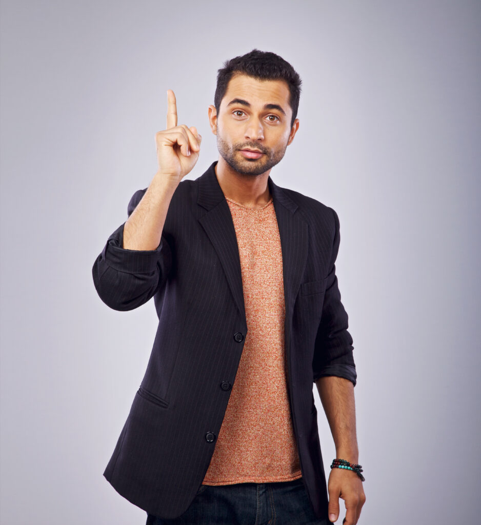 portrait of a friendly guy pointing upwards BpZNKIEYe