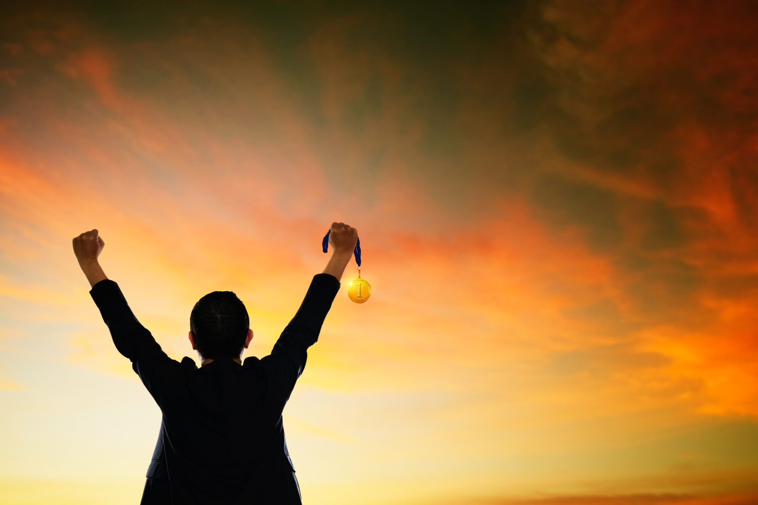 graphicstock win concept businessman holding gold medal HdXlL13vesx scaled