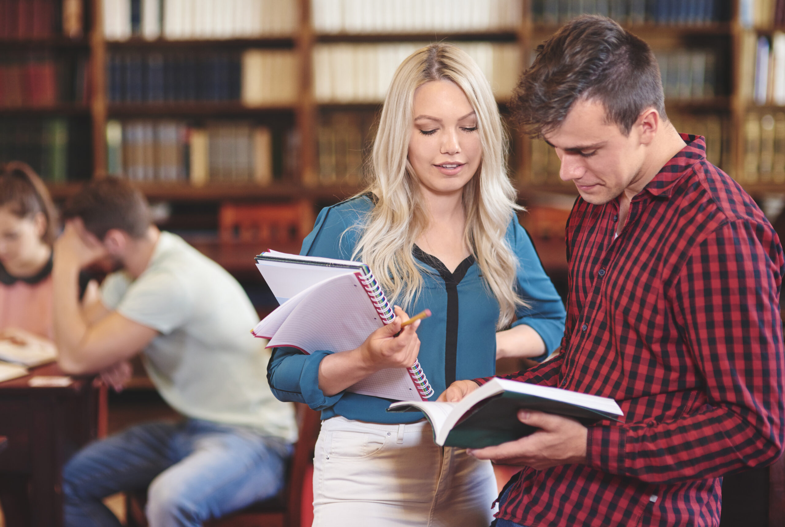 storyblocks couple of students reading book in a university library Swx7Jj1F9f scaled
