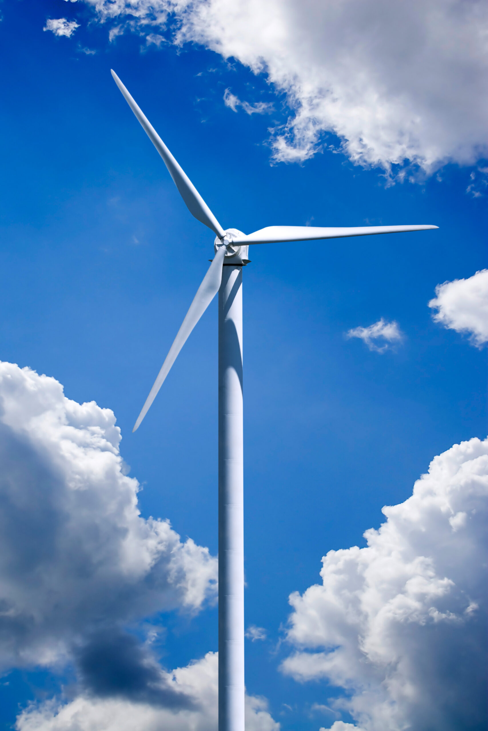 a single wind turbine over a cloud filled blue sky clipping path is included for easy isolation of the turbine HtJr Ari scaled