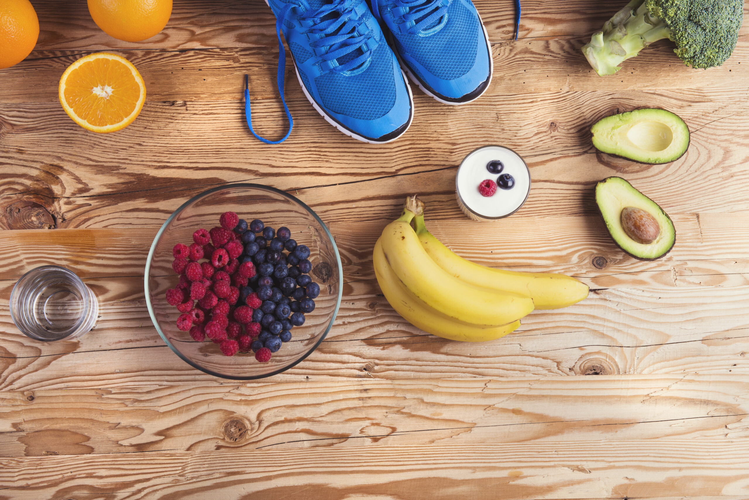 graphicstock pair of running shoes and healthy food composition on a wooden table background B0hXVuaWb scaled